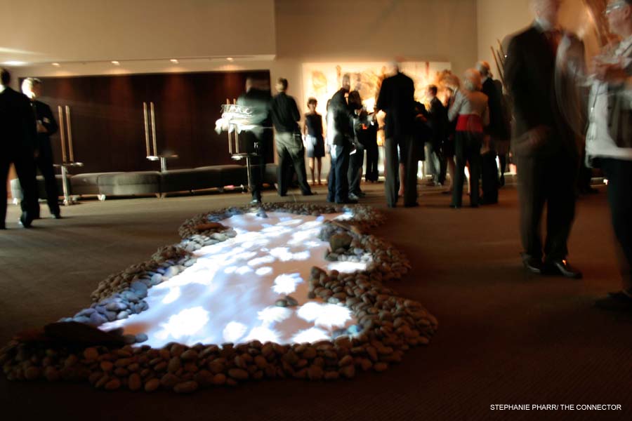 Guests chat around a rock garden installation at the grand opening of SCAD's Digital Media Center.